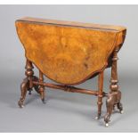 A Victorian oval shaped figured walnut Sutherland table raised on turned supports 70cm h x 90cm w