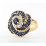 An 18ct yellow gold sapphire and diamond swirl ring, size M