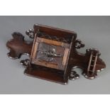 A Victorian carved oak hanging corner cabinet enclosed by a panelled door, the base with gallery