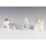 A Lladro figure of a puppy 14cm, a ditto of a seated clown with a puppy on his lap 9cm and a