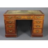 A mahogany kneehole desk with inset green writing surface above 1 long and 8 short drawers 75cm h