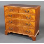 A Georgian style crossbanded mahogany chest of 2 short and 3 long drawers with swan neck drop