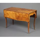 A French figured walnut drop flap occasional table of serpentine outline, raised on cabriole