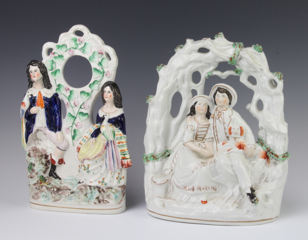 A Victorian Staffordshire arbour group of a seated couple with a spaniel 30cm, a ditto pocket