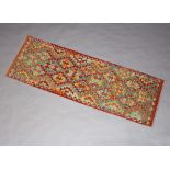 A yellow, brown and green ground Cheli Kilim runner 196cm x 65cm