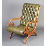 A Georgian style mahogany framed slipper open arm chair, upholstered in green buttoned back leather,