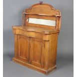 A Victorian bleached mahogany chiffonier with arched mirrored back, the base of serpentine outline