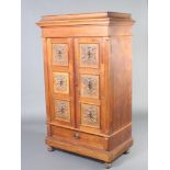 A Continental carved walnut press cabinet, fitted 5 shallow trays enclosed by a pair of panelled