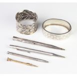 A Victorian repousse silver napkin ring, 3 propelling pencils, a bangle and a gilt toothpick