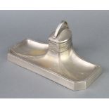 An Art Nouveau plated inkwell raised on outswept base with an associated glass liner 10cm x 25cm x
