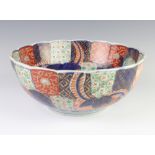 An Imari scalloped bowl decorated with flowers 28cm There is some rubbing to the decoration