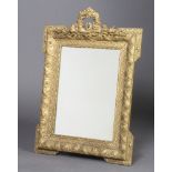 A 19th Century rectangular plate wall mirror contained in a decorative gilt frame surmounted by a