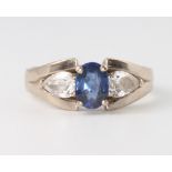 An 18ct white gold oval sapphire and diamond ring, the centre stone approx 1.18ct flanked by pear