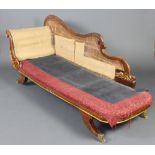 A William IV mahogany show frame chaise longue raised on outswept supports with brass caps and