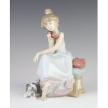 A Lladro figure of a young girl on a telephone with a hound at her feet 5466 20cm The phone