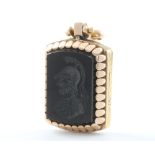 A yellow gold carved intaglio onyx locket