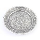 A circular Indian repousse silver dish with floral decoration 19cm, 166 grams