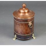 An Art Nouveau cylindrical copper and brass coal bin with ring drop handles, raised on paw feet 46cm