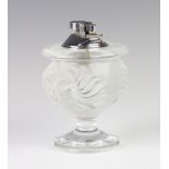 A Lalique frosted glass cigarette lighter with lion masks, signed Lalique France, 12cm There are