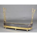A Victorian brass and pierced steel fender, the sides fitted removable associated companion stands