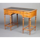 A 19th Century French walnut writing table with inset black writing surface above 1 long and 4 short