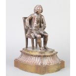 A bronze figure of a seated 18th Century gentleman with book, raised on a shaped base, unisgned 20cm