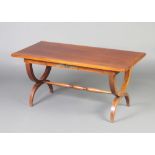 An Empire style mahogany rectangular coffee table with gilt metal mounts, raised on X framed