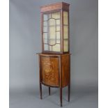 An Edwardian inlaid mahogany bow front display cabinet, the upper section enclosed by astragal