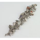 A silver charm bracelet, 143 grams