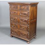 A Jacobean style oak chest of 5 long drawers with geometric mouldings, raised on bun feet 120cm h