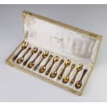 A set of 12 silver gilt coffee spoons 160 grams, cased