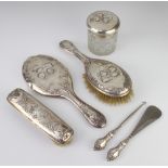 A Victorian repousse silver Reynolds Angels dressing table set comprising hair brush, clothes brush,
