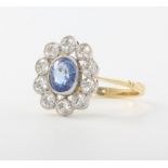 An 18ct yellow gold oval sapphire and diamond cluster ring, the centre stone approx. 1.35ct
