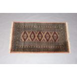 A pink ground Bokhara rug with 5 stylised diamonds to the centre within a multi row border 162cm x