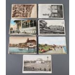 A small collection of black and white and coloured postcards