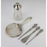 A circular silver hand mirror Birmingham 1949 and 4 mounted items