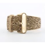 A 9ct yellow gold bark finish buckle ring, size R, 7 grams