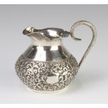 An Indian repousse silver jug with sprawl decoration, 9cm, 126 grams