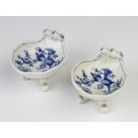 A pair of Meissen shell shaped salts decorated with flowers, raised on scroll feet, 8cm