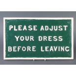 A rectangular cast iron sign marked "Please adjust your dress before leaving" 22cm x 37cm