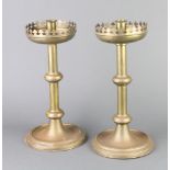 A pair of Victorian brass ecclesiastical style candlesticks with wavy rims and deep sconces 33cm h x