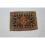 A black and red ground Persian Farahan rug 71cm x 54cmFringe missing and slight flecking in places