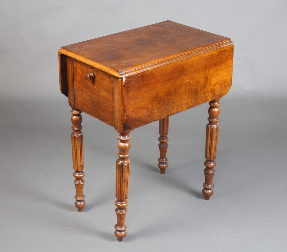 A Victorian walnut drop flap work table with quarter veneered top fitted 2 long drawers and cupboard