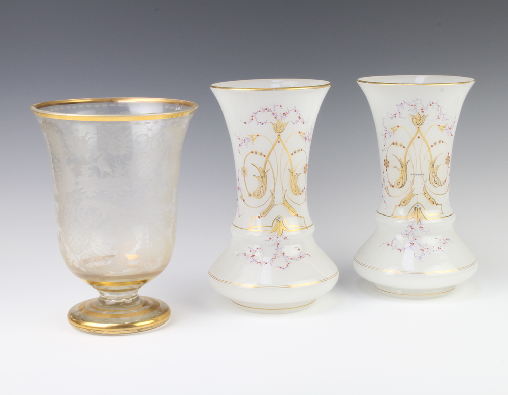 A Bohemian cut glass gilt decorated vase 24cm and a pair of opaline gilt decorated glass vases 25cm