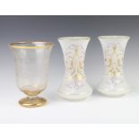 A Bohemian cut glass gilt decorated vase 24cm and a pair of opaline gilt decorated glass vases 25cm