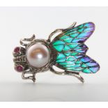 A silver pearl and enamel moth brooch