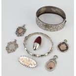 A silver bangle and minor silver jewellery, 82 grams