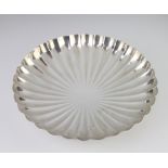 A circular scalloped silver shallow bowl on ball feet, Sheffield 1979, 27cm, 595 gramsThere are