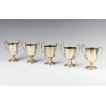 An Edwardian silver sports trophy, London 1909 and 4 others, 442 grams