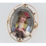 A 9ct yellow gold mounted painted porcelain brooch depicting a lady 43mm